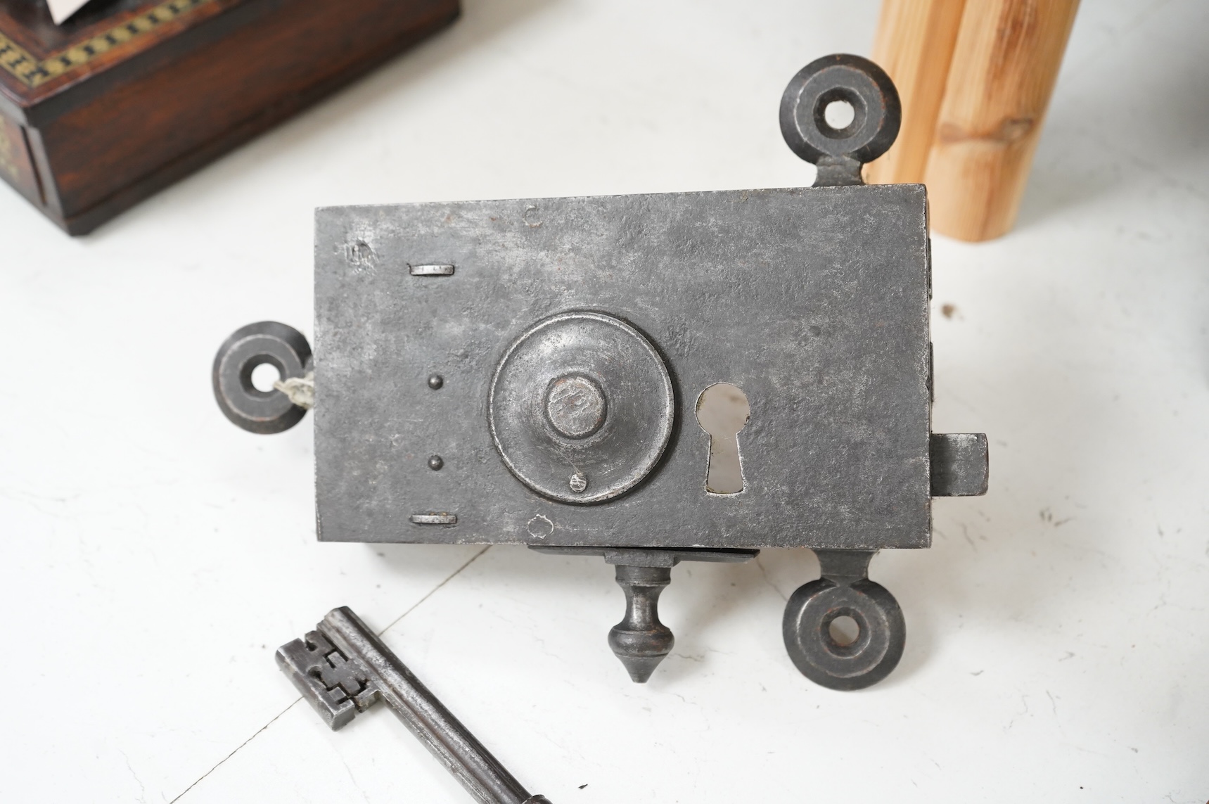 A 17th century steel door lock and key, lock 24cm wide.